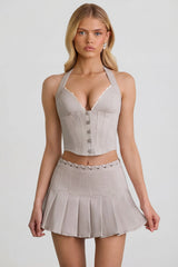 Low-Rise Pleated Mini Skirt in Ecru